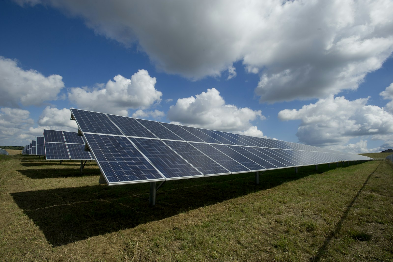 Solar panels beneath a partly cloudy sky